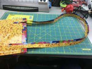 Image of attaching duct tape strap to a duct tape iPad case.