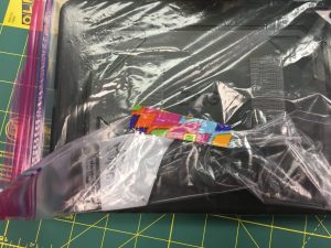 Image of tape on the back of an iPad in a Ziploc bag
