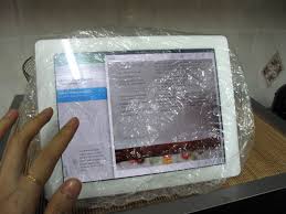 iPad in a clear shower cap