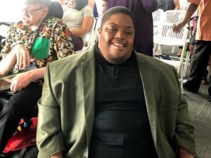 Image of participant in a suit, at graduation