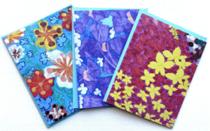Three beautiful hand-drawn greeting cards with images of flowers in purple, red, yellow, and. blue.