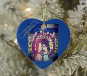 Blue heart ornament with drawing on a white Christmas tree.