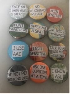 Buttons with disability pride and AAC messages.